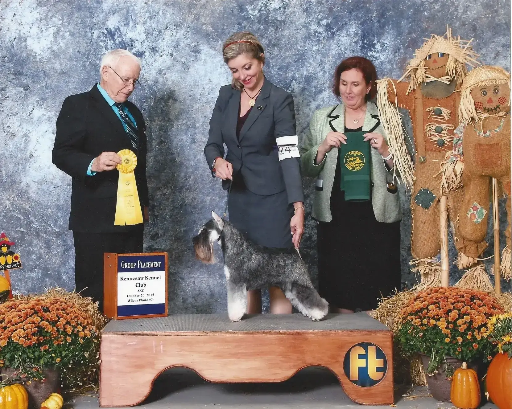 Dog show winners with awards and decorations.